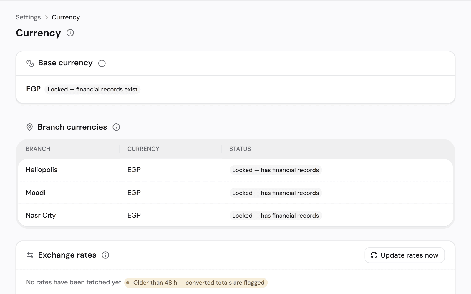Currency settings: the clinic's base currency, the currency of each branch and the exchange rates in use.